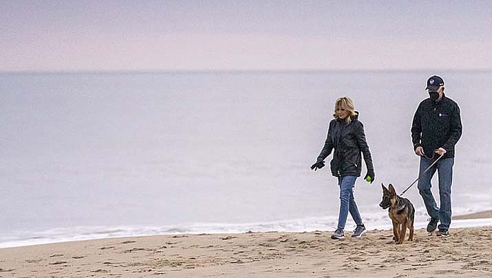President Joe Biden fell when he tried to get off his bike at the end of a ride Saturday at Cape Henlopen State Park near his beach home in Delaware. He was not injured. Biden and First Lady Jill Biden are shown walking on the beach in Delaware in this file photo. (White House photo, Public domain)