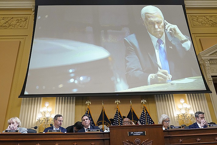 A committee exhibit shows former Vice President Mike Pence talking on the phone from his secure location during the riot, as the House select committee investigating the Jan. 6, 2021, attack on the Capitol holds a hearing at the Capitol in Washington, Thursday, June 16, 2022. (AP Photo/Susan Walsh)