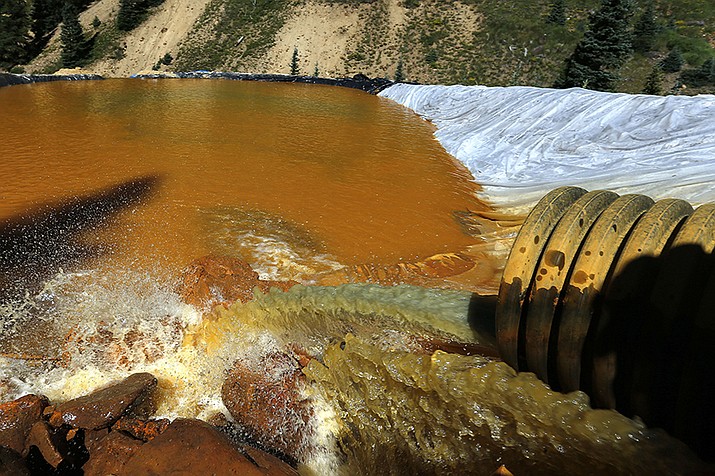Water flows through a series of sediment retention ponds built to reduce heavy metal and chemical contaminants from the Gold King Mine outside Silverton, Colorado in 2015. New Mexico and the U.S. government have reached a $32 million settlement over the 2015 mine spill that polluted rivers in three western states. (AP Photo/Brennan Linsley, File)