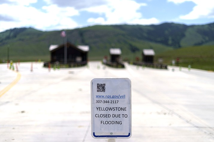 The entrance to Yellowstone National Park, a major tourist attraction, sits closed due to the historic floodwaters June 15 in Gardiner, Montana. (AP Photo/David Goldman, File)
