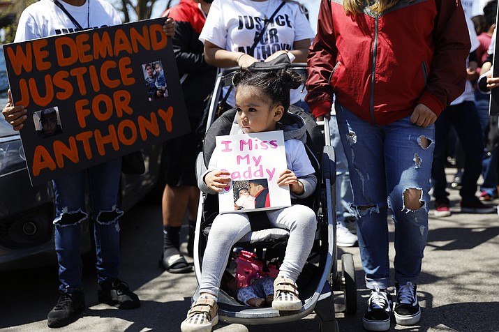 In this Saturday, May 1, 2021 file photo, Ailani Alvarez, 2, daughter of Anthony Alvarez who was shot by the police, holds a sign reading "I miss my daddy" during a protest in Chicago. Chicago police officers will no longer be allowed to chase people on foot simply because they run away or give chase over minor offenses, the department said Tuesday, June 21, 2022, more than a year after two foot pursuits ended with officers fatally shooting a 13-year-old boy and 22-year-old man. (Shafkat Anowar/AP, File)