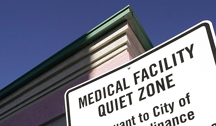 A sign indicating a “Medical Facility Quiet Zone” is displayed outside a women’s health clinic. (AP Photo/Rogelio V. Solis, File)