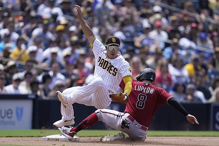 San Diego Padres third baseman Ha-Seong Kim, left, falls over Arizona Diamondbacks’ Jordan Luplow (8) after tagging him out on a fielder’s choice by Jake Hager during the fourth inning of a game Wednesday, June 22, 2022, in San Diego. Hager was safe at first on the play. (Gregory Bull/AP)