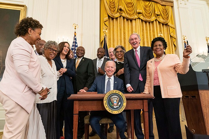 The scene was all smiles in June 2021 as President Joe Biden, flanked by lawmakers and advocates, signed a bill making Juneteenth a federal holiday. A year later, the day is slowly gaining in popularity, but is not widely observed. (Chandler West/The White House)