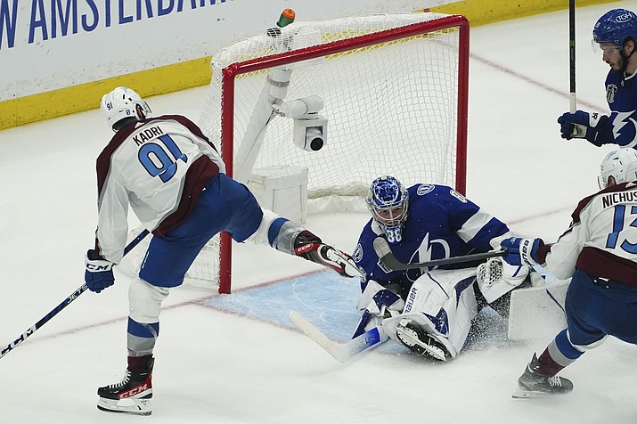 Colorado Avalanche center Nazem Kadri shoots the puck into the top of the goal past Tampa Bay Lightning goaltender Andrei Vasilevskiy (88) for a goal during overtime of Game 4 of the Stanley Cup Finals on Wednesday, June 22, 2022, in Tampa, Fla. (John Bazemore/AP)