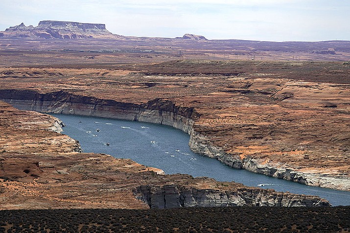 Boats move along Lake Powell in the Upper Colorado River Basin on June 9, 2021, in Wahweap, Ariz. (Ross D. Franklin/AP, File)