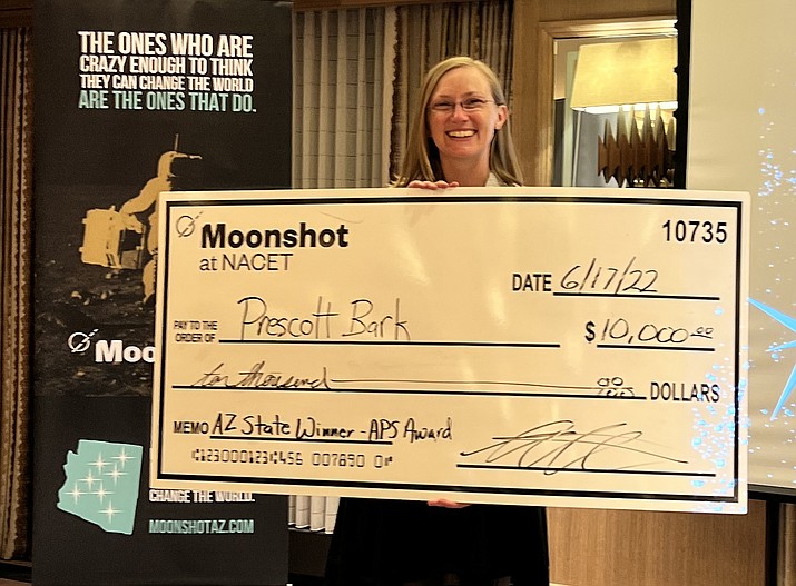 Elaine O’Connor, with check, won the second annual statewide 2022 Moonshot Pioneer Pitch event June 17, 2022, in Flagstaff for her start-up called Prescott Bark. She captured the competition’s grand prize of $10,000. (Courtesy/Yavapai College SBDC)
