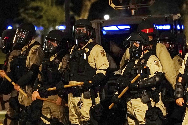 Police in riot gear surround the Arizona Capitol after protesters reached the front of the Arizona Sentate building as protesters reacted to the Supreme Court decision to overturn the landmark Roe v. Wade abortion decision Friday, June 24, 2022, in Phoenix. (Ross D. Franklin/AP)