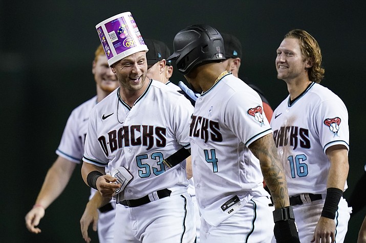 Arizona Diamondbacks' Christian Walker (53) celebrates with Ketel Marte (4) and Jake Hager (16) after Walker grounder on which Josh Rojas scored the winning run against the San Diego Padres during the ninth inning of a baseball game Tuesday, June 28, 2022, in Phoenix. The Diamondbacks won 7-6. (Ross D. Franklin/AP)