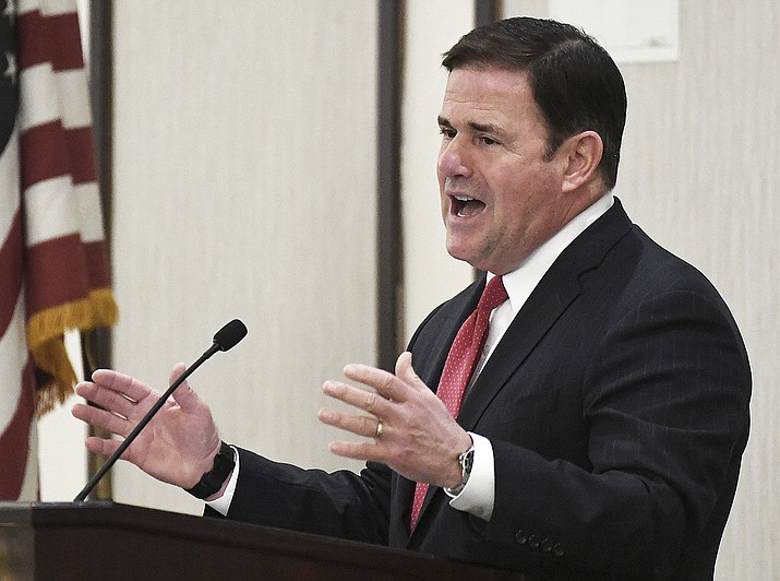 Arizona Gov. Doug Ducey re-delivers his State of the State address in front of a Yuma crowd, Thursday, Feb. 17, 2022, inside Pivot Point Conference Center. On Tuesday, June 28, 2022, Ducey signed into law his eighth and final state budget, an $18 billion spending plan that uses a record surplus to invest in education and infrastructure while lowering state debt and preparing for an economic downtown. (Randy Hoeft/The Yuma Sun via AP, File)