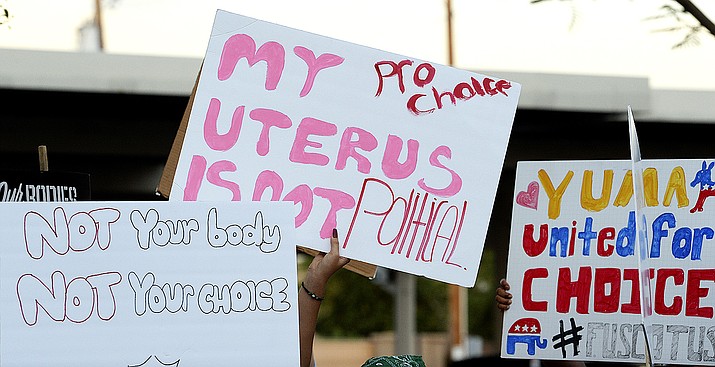 Abortion-rights activists march with signs carrying various messages during a demonstration from Heritage Library to Yuma City Hall, Wednesday, June 29, 2022, in Yuma, Ariz. (Randy Hoeft/The Yuma Sun via AP)