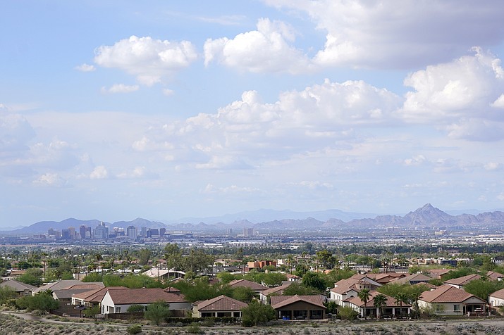 With the downtown skyline in the background, expansive urban sprawl continues to grow, Thursday, Aug. 12, 2021, in Phoenix. A county in the heart of metro Phoenix and several counties in Texas' fastest-growing metro areas had the biggest jumps in the numbers of white, Black, Asian and Hispanic residents last year, while California's Inland Empire also had among the biggest booms in Hispanic residents, according to new estimates released Thursday, June 30, 2022 (Ross D. Franklin/AP, File)