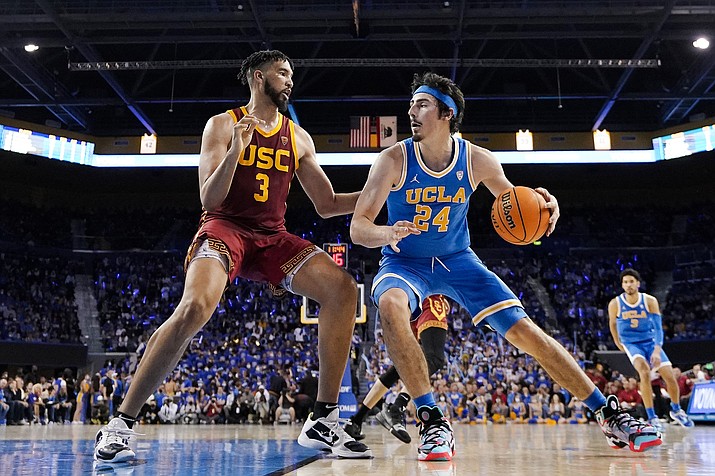 UCLA guard Jaime Jaquez Jr., right, tries to get by Southern California forward Isaiah Mobley during the second half of a game on March 5, 2022, in Los Angeles. UCLA and Southern California are planning to leave the Pac-12 for the Big Ten Conference in a seismic change that could lead to another major realignment of college sports. A person who spoke to The Associated Press on Thursday, June 30, 2022, on condition of anonymity because the schools' talks with the Big Ten have not been made public said the schools have taken steps to request an invitation to join the conference. (Mark J. Terrill/AP, File)