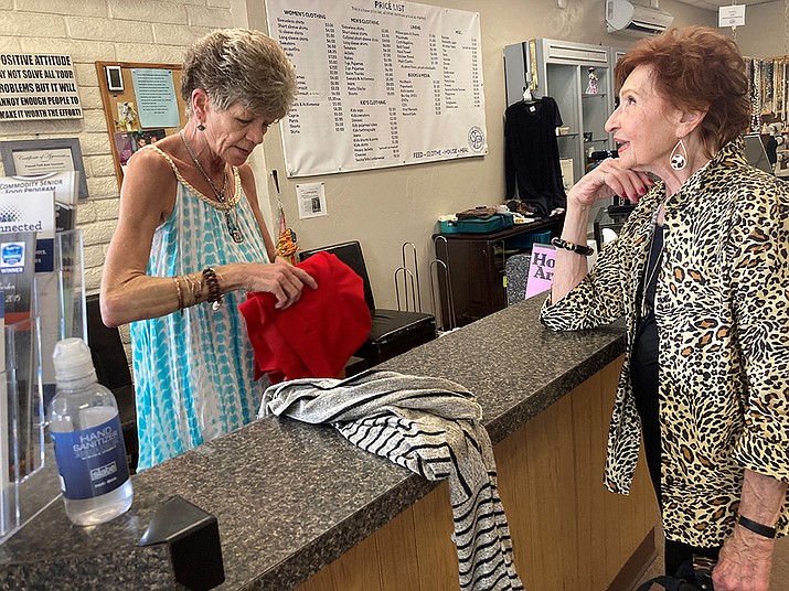 Loyal area thrift store shopper Bonnie Andrews, right, picks up a sweater for a bargain on her second stop of a thrift store tour at the St. Vincent de Paul Society Thrift Store in Prescott last week. Cashier Lori Owens shares how much she loves supporting the store that donates to so many Catholic charities that benefit children and families in the community. (Nanci Hutson/Courier)