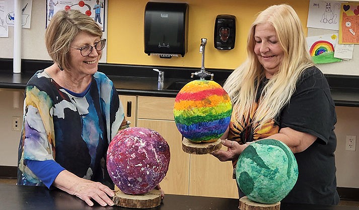 Debbie Crincoli (right), Wildcat Extended Day Program director shows dragon eggs kids recently made to Jamiss Sebert, Rotary Club of Sedona Youth Services director.