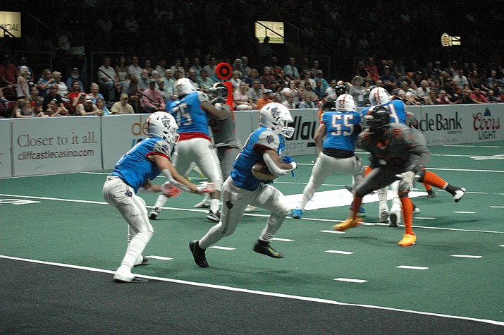 Northern Arizona  Wranglers QB Kaleb Barker hands off to Israel Tucker vs. the Bismarck Bucks Bucks Saturday night, July 9, 2022, at Findlay Toyota Center in Prescott Valley The Wranglers defeated the  Bucks 46-21, Saturday night, to finish with an 8-0 regular-season record at home. (Doug Cook/Courier)