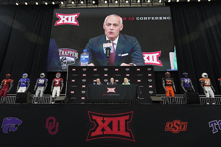 Incoming Big 12 Commissioner Brett Yormark, center, speaks with outgoing Commissioner Bob Bowlsby, left, and Baylor President Linda Livingstone looking on during a news conference opening the NCAA college football Big 12 media days in Arlington, Texas, Wednesday, July 13, 2022. (LM Otero/AP)