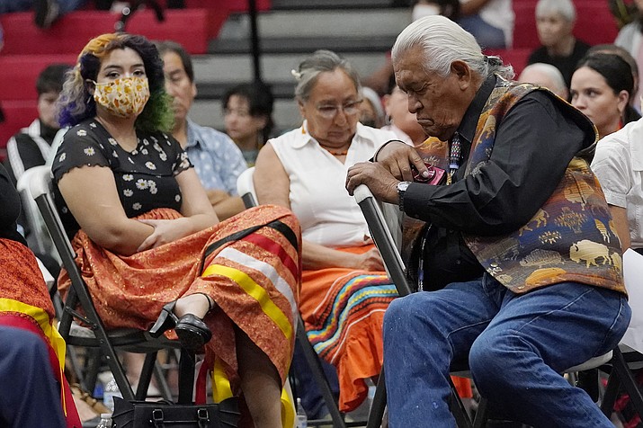 Ray Doyah, the first to speak on his experiences at an Indian boarding school, bows his head as he listens to others speak at a meeting to hear about the painful experiences of Native Americans who were sent to government-backed boarding schools designed to strip them of their cultural identities, Saturday, July 9, 2022, in Anadarko, Okla. (AP Photo/Sue Ogrocki)