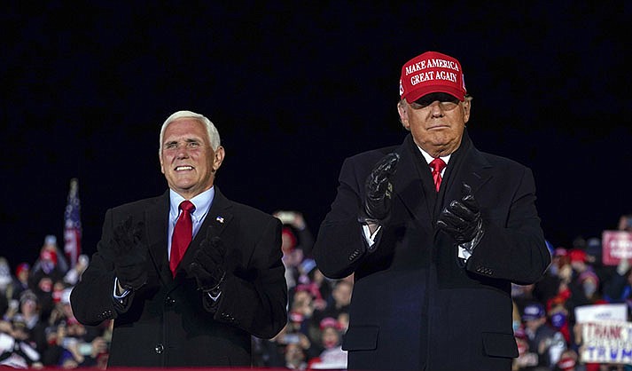 Then-President Donald Trump arrives for a campaign rally at Gerald R. Ford International Airport, Nov. 2, 2020, in Grand Rapids, Mich., with then-Vice President Mike Pence (AP Photo/Evan Vucci, File)