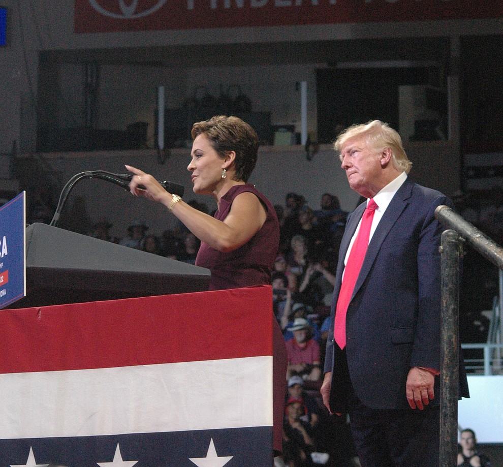 Kari Lake, candidate for Arizona governor, flanked by Donald Trump, addresses the crowd during the "Save America" rally at the Findlay Toyota Center in Prescott Valley Friday evening, July 22, 2022. (Tim Wiederaenders/Daily Courier)