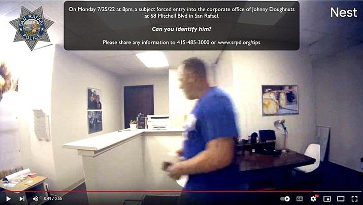 This Monday, July 25, 2022, image taken from a surveillance video posted on YouTube shows a subject who forced entry into the corporate office of Johnny Doughnuts in San Rafael. The burglar had to double back to the scene of the crime, the corporate office of a the San Francisco Bay Area doughnut company – this past week because he forgot his keys. Police are asking for the public's help in identification. (San Rafael Police Department via AP)