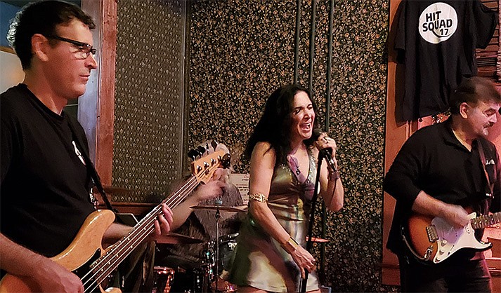 From left: Dru on bass, Scott Henderson on drums; and Joe Seratto on guitar. Center, on vocals is lead singer Lucy Hill. (Photo courtesy of Sound Bites Grill)