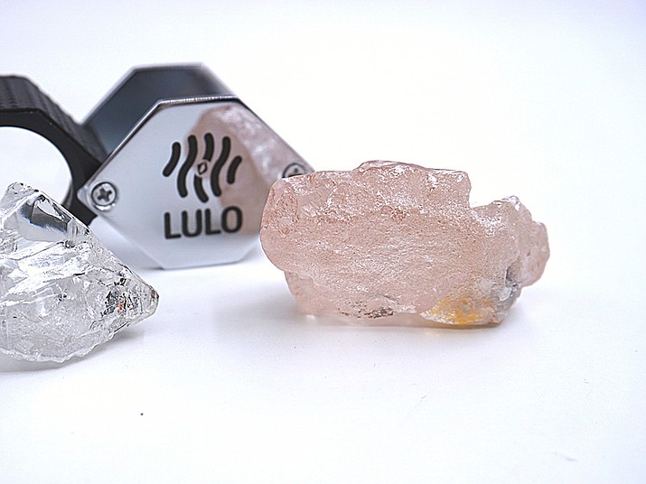 This photo supplied by Lucapa Diamond Company on Wednesday, July 27, 2022, shows the 170 carat pink diamond, right, recovered from Lulo, Angola. A big pink diamond of 170 carats has been discovered in Angola and is claimed to be the largest such gemstone found in 300 years. Called the “Lulo Rose,” the diamond was found at the Lulo alluvial diamond mine. The mine’s owner, the Lucapa Diamond Company, on Wednesday announced the discovery of the large pink diamond on its website. (Lucapa Diamond Company via AP)