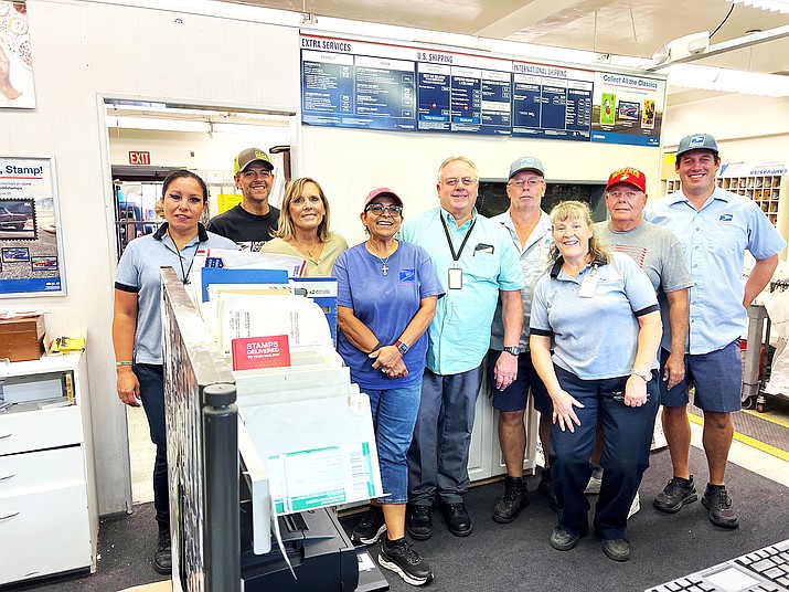 William's postmaster, Kent Boyack and coworkers on his last day after 20 years with the USPS. (Wendy Howell/WGCN)