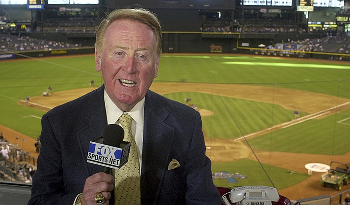 Los Angeles Dodgers television play-by-play announcer Vin Scully rehearses before a baseball game between the Dodgers and the Arizona Diamondbacks in Phoenix on July 3, 2002. Scully, whose dulcet tones provided the soundtrack of summer while entertaining and informing Dodgers fans in Brooklyn and Los Angeles for 67 years, died Tuesday night, Aug. 2, 2022, the team said. He was 94. (AP Photo/Paul Connors, File)