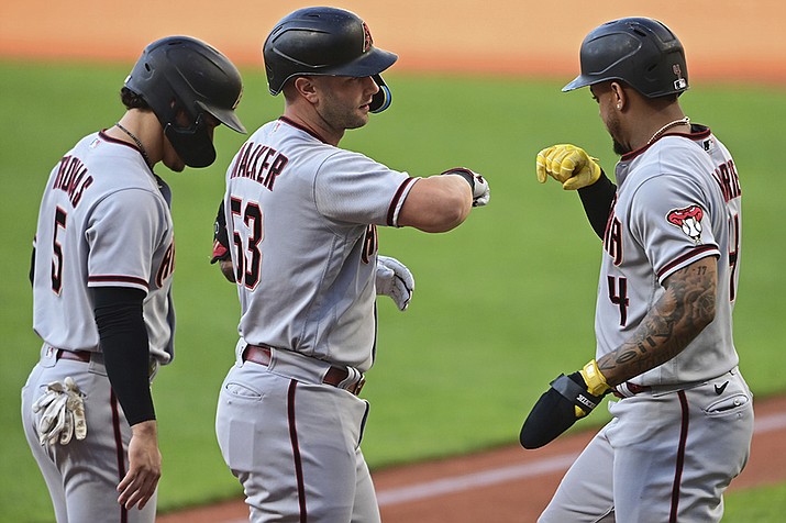 Arizona Diamondbacks' Christian Walker, center, is congratulated by Ketel Marte, right, and Alek Thomas after hitting a three-run home run off Cleveland Guardians starting pitcher Triston McKenzie during the first inning of a baseball game Tuesday, Aug. 2, 2022, in Cleveland. (David Dermer/AP)