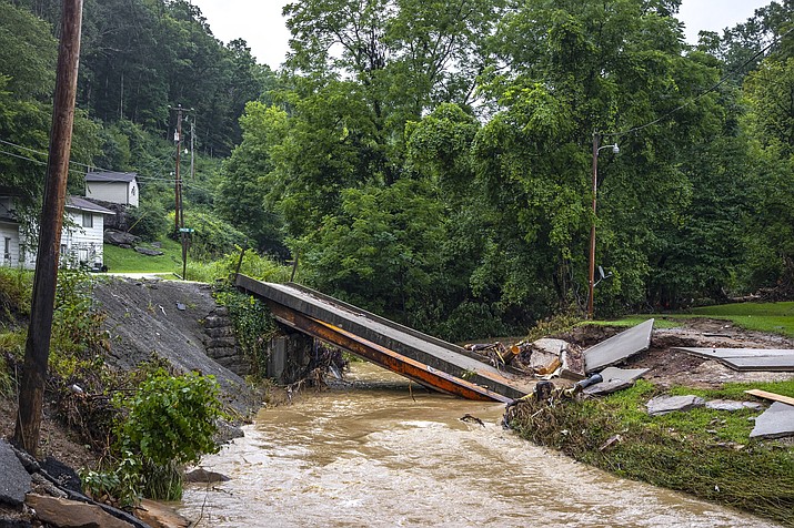 A bridge across Grapevine Creek to a home near Grapevine, Ky., is collapsed Monday, Aug. 1, 2022, following historic floods last week. (Ryan C. Hermens/Lexington Herald-Leader via AP)