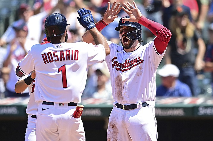 Cleveland Guardians' Amed Rosario, left, is congratulated by Austin Hedges after hitting a three-run home run off Arizona Diamondbacks starting pitcher Tommy Henry during the fifth inning Wednesday Aug. 3, 2022, in Cleveland. (David Dermer/AP)