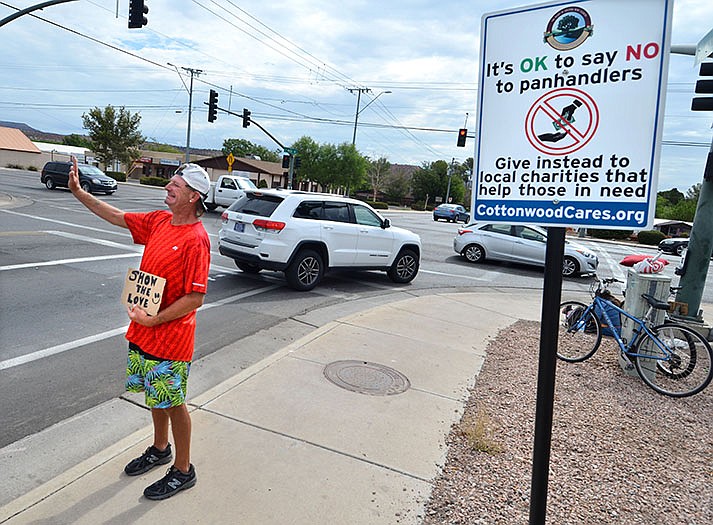 Corey Strache was on the corner of Mingus Avenue and Main Street across from Circle K on Thursday, where one of the panhandling police signs is now located holding his own sign, which read “Show the Love.” (VVN/Vyto Starinskas)