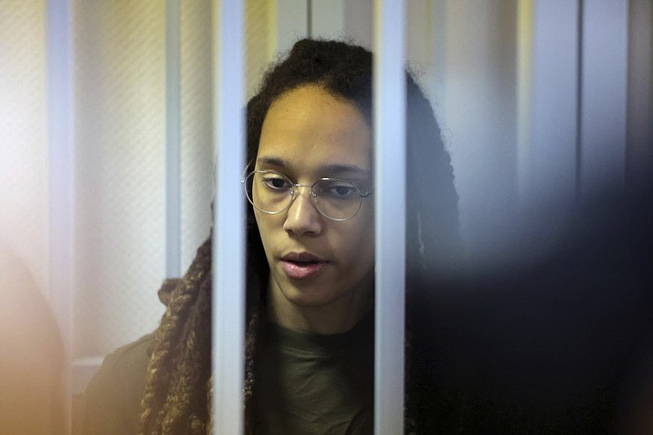 WNBA star and two-time Olympic gold medalist Brittney Griner stands behind bars in a courtroom for a hearing, in Khimki just outside Moscow, Russia, Tuesday, Aug. 2, 2022. Since Brittney Griner last appeared in her trial for cannabis possession, the question of her fate expanded from a tiny and cramped courtroom on Moscow's outskirts to the highest level of Russia-US diplomacy. (Evgenia Novozhenina/Pool Photo via AP)