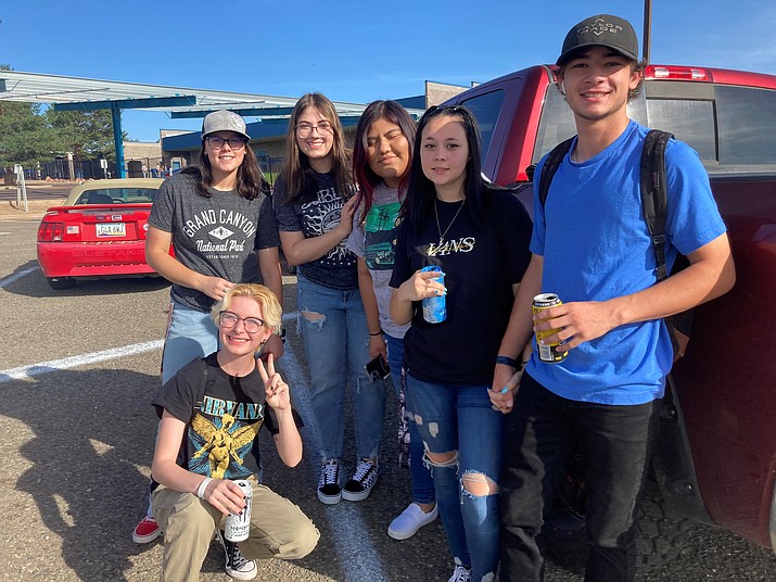 Chino Valley High School seniors gather for an impromptu parking lot photo after greeting each other with hugs and high fives as they prepared for their last, first day of K-12 school. Kneeling: Emerson Furtado then left to right: Kamryn Clark, Monse Flores, Isabel Martinez, Xander Earles and Hunter Husk. (Nanci Hutson/Courier)