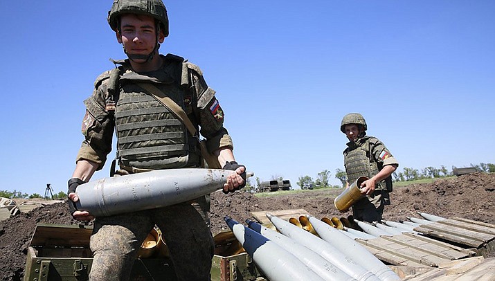 Russian forces shelled a Ukrainian city close to Europe’s biggest nuclear power plant Thursday, reinforcing warnings from the U.N. nuclear chief that the fighting around the site could lead to a disastrous accident. Russian soldiers are shown carrying artillery shells. (Photo by Ministry of Defense of the Russian Federation, cc-by-sa-4.0, https://bit.ly/3uF2sAv)