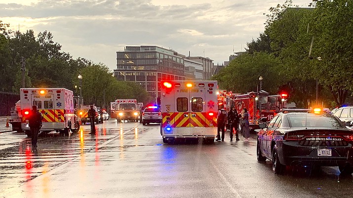 In this photo provided by @dcfireems, emergency medical crews are staged on Pennsylvania Avenue between the White House and Lafayette Park, Thursday evening, Aug. 4, 2022 in Washington. Two people who were critically injured in a lightning strike in Lafayette Park outside the White House have died, police said Friday. Two others remained hospitalized with life-threatening injuries. Authorities haven't revealed how the people were injured, other than to say they were critically hurt in the lightning strike. (@dcfireems via AP)