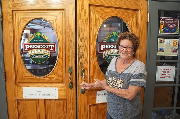 Roxane Nielsen stands at the entrance of the Prescott Brewing Company on Thursday, May 21, 2020, the first day the restaurant reopened after the COVID-19 shutdown. The Nielsens have filed for Bankruptcy, Chapter 11 reorganization and protection, and the PBC has been closed since June 25, 2022. (Courier file photo)