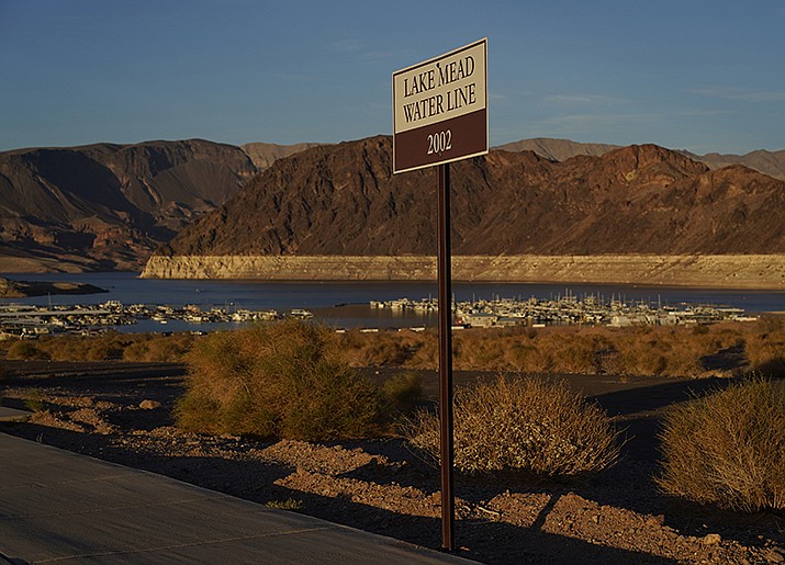 A sign marks the water line from 2002 near Lake Mead at the Lake Mead National Recreation Area, Saturday, July 9, 2022, near Boulder City, Nev. The largest U.S. reservoir has shrunken to a record low amid a punishing drought and the demands of 40 million people in seven states who are sucking the Colorado River dry. (John Locher/AP)