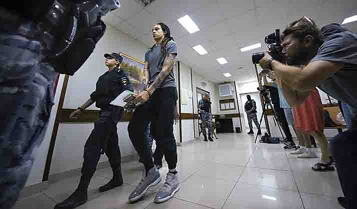 WNBA star and two-time Olympic gold medalist Brittney Griner is escorted from a court room after a hearing, in Khimki just outside Moscow, Russia, Thursday, Aug. 4, 2022.  (AP Photo/Alexander Zemlianichenko)