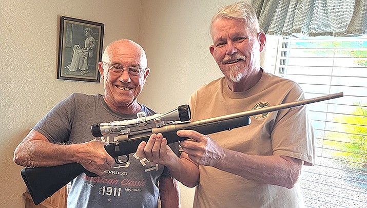 Ed Murray, left, of Lake Havasu City, gives Don Martin a stainless steel .270 caliber Mossberg rifle that he donated to the American Elk Society’s Heroes Rising Outdoors program that serves disabled veterans. (Courtesy photo)