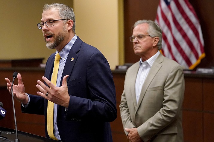 Pinal County Board of Supervisors Chairman Jeffrey McClure, right, listens as Pinal County Attorney Kent Volkmer addresses election day ballot shortages Pinal county, Wednesday, Aug. 3, 2022, in Florence. (Matt York/AP)