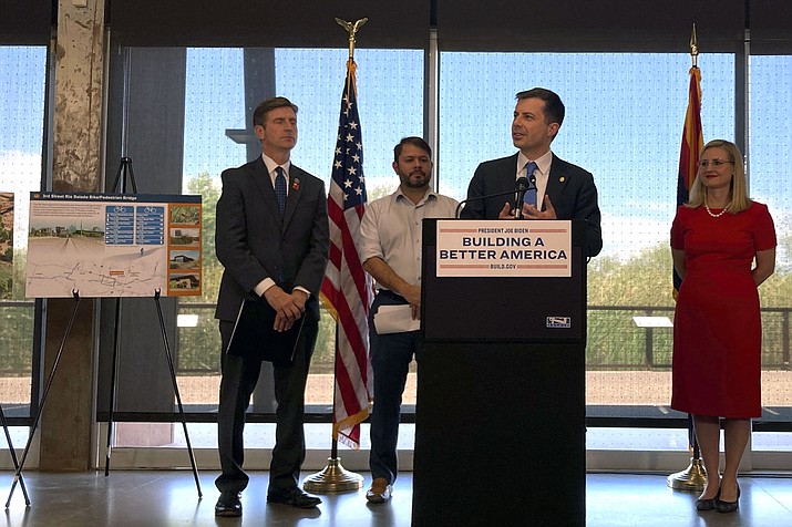 Transportation Secretary Pete Buttigieg, center, flanked by, from left to right, Congressman Greg Stanton, Congressman Ruben Gallego and Phoenix Mayor Kate Gallego, announces the awarding of a grant Thursday, Aug. 11, 2022, at the Rio Salado Audubon Center in Phoenix. The $2.2 billion grant for local infrastructure projects will pave the way for new bridges, roads, bike lanes, railways and ports in scores of communities across the country. (Terry Tang/AP)