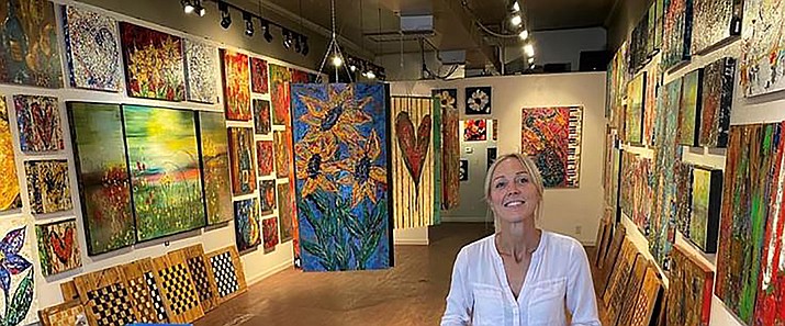Carrie Weldon stands among her variety of paintings in the newly opened Carrie Weldon Gallery, 219 W. Gurley St., Prescott. The business opened at the end of July 2022. (Courtesy photo)