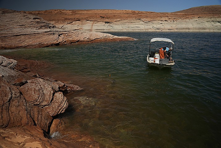 Shown is Lake Powell in Page. A small plane that plunged into the lake that straddles the Arizona-Utah state line, killing two people and injuring five, was carrying six French tourists plus a pilot, authorities said Tuesday.