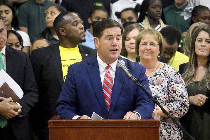 Republican Arizona Gov. Doug Ducey speaks at an event touting a new universal school voucher program he signed into law in July and resigned again in a ceremony Tuesday, Aug. 16, 2022 at Phoenix Christian Preparatory School. The law will be the nation's most expansive voucher program, allowing all students to take public money to attend private schools, if opponents fail to block it by collecting enough signatures to refer it to the ballot. (Bob Christie/AP)