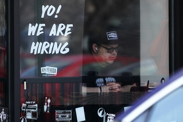 A hiring sign is displayed at a restaurant in Schaumburg, Ill., Friday, April 1, 2022. (Nam Y. Huh/AP, File)