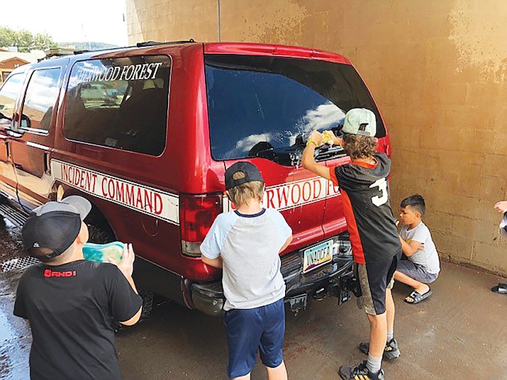 Williams Youth Football players clean a Sherwood Fire District truck at their fundraising car wash and bake sale Aug. 12. (Photo/Sherwood Fire)