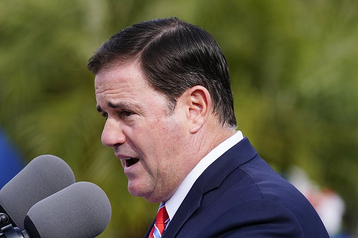 Arizona Republican Gov. Doug Ducey speaks at a ceremony on Dec. 7, 2021, in Phoenix. Ducey and the GOP leaders of the state House and Senate are urging the state Supreme Court to overrule lower court judges and block three voter initiatives from the ballot. (Ross D. Franklin/AP, File)