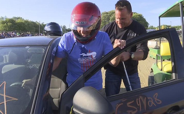 Michigan Supreme Court Justice Richard Bernstein, who is blind, gets into a car to drive for the first time at the Genesee County fairgrounds in Mt. Morris, Mich., on Tuesday, Aug. 23, 2022. Sheriff Chris Swanson, rear, rode in the passenger seat and gave instructions. (WNEM-TV via AP)